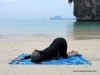 Photo of Elle Bieling doing Quarter Dog Pose in Yin Yoga on Pranang Beach, Railay, Thailand