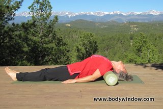 Fish Pose using a foam roller.