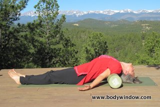 Fish Pose using a foam roller.